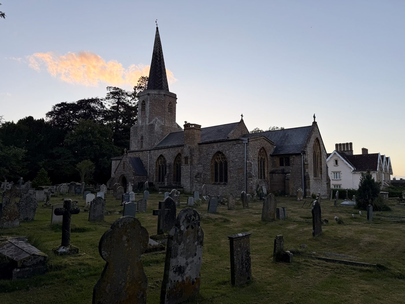 The church of St Andrew and St Mary at Pitminster at dusk, seen across the churchyard
